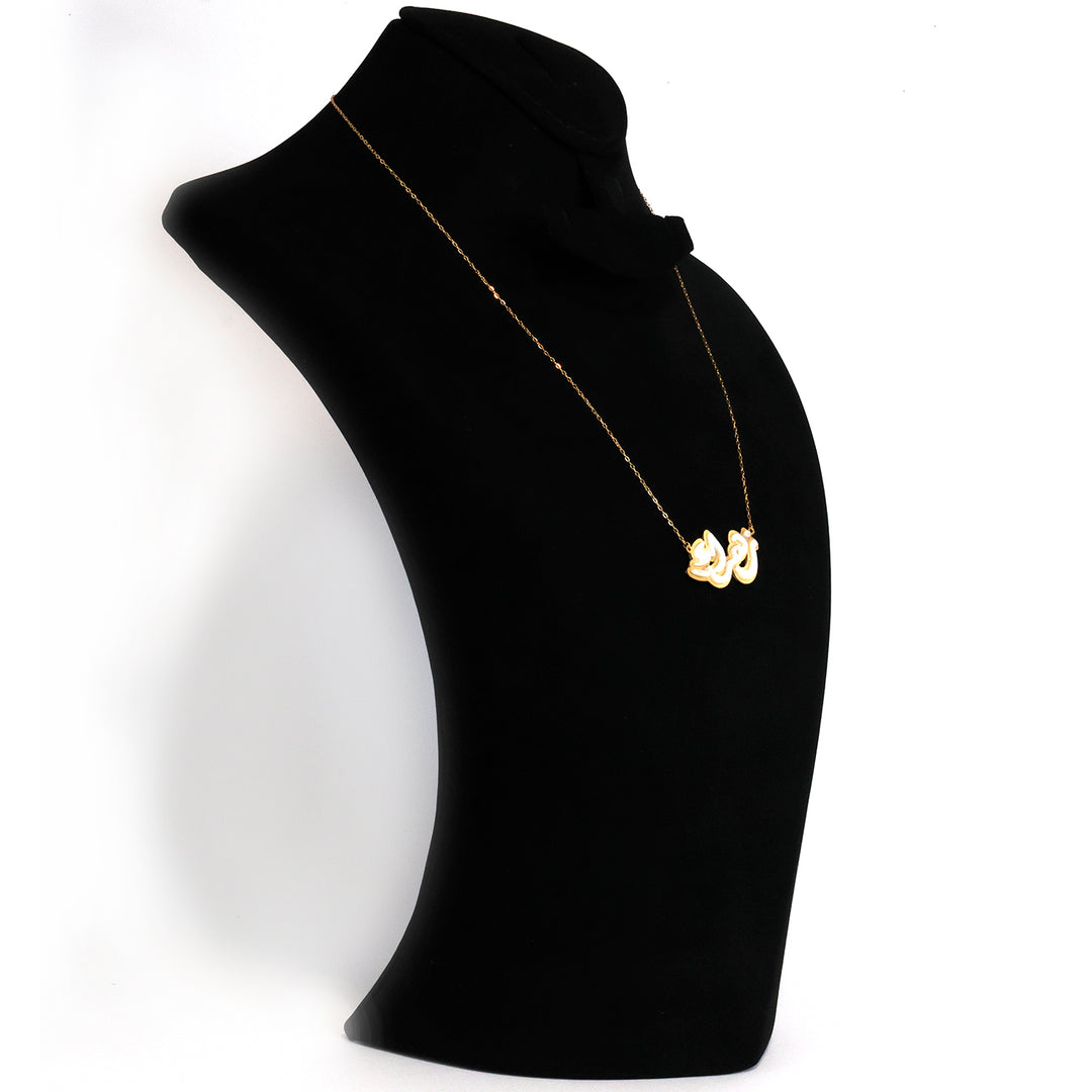 Gold necklace with a heart pendant on a black mannequin bust against a white background