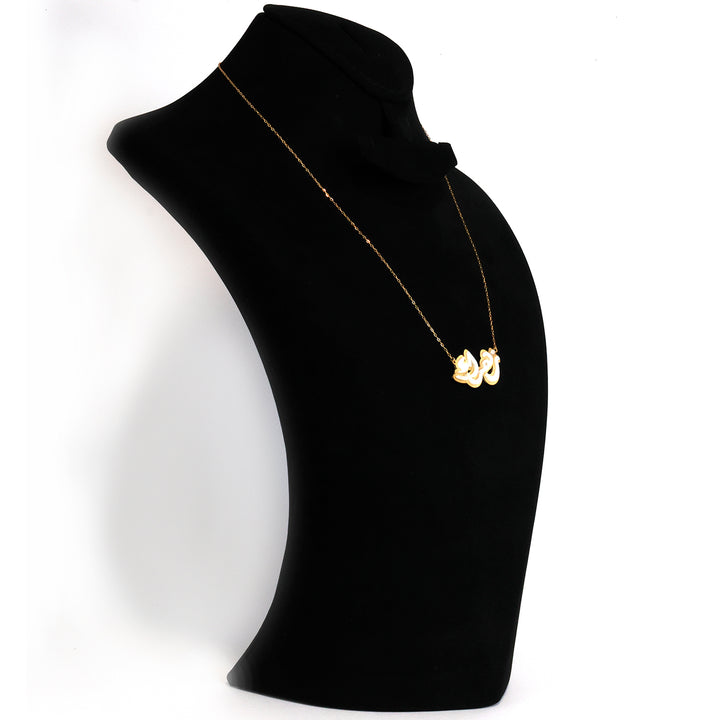 Gold necklace with a heart pendant on a black mannequin bust against a white background