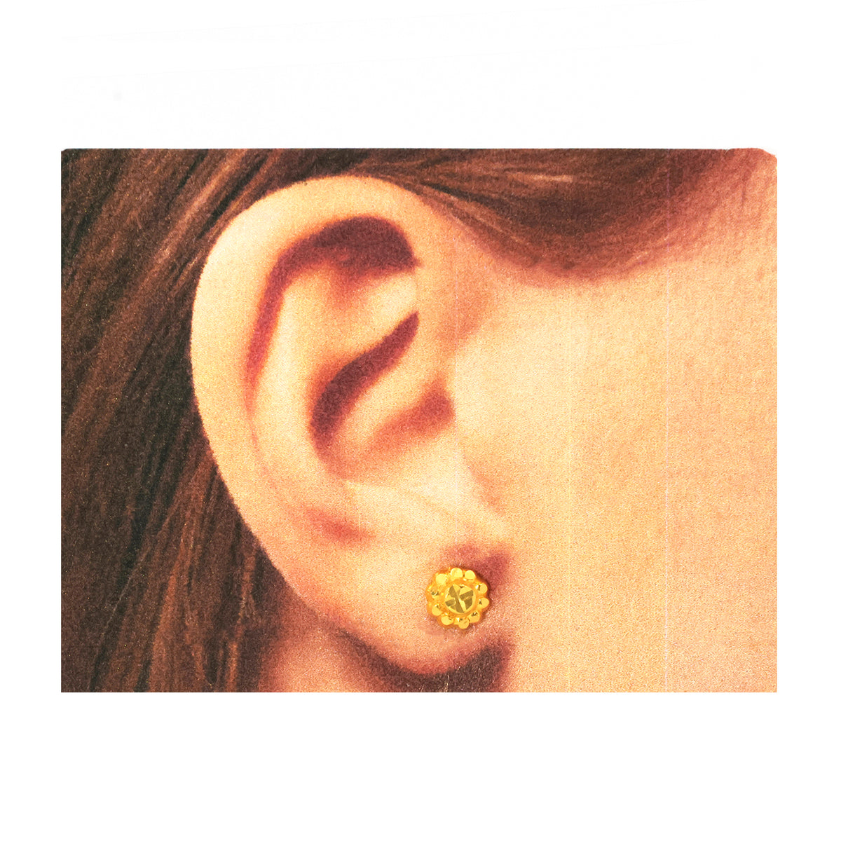 Close-up of an ear wearing a gold earring with a white background