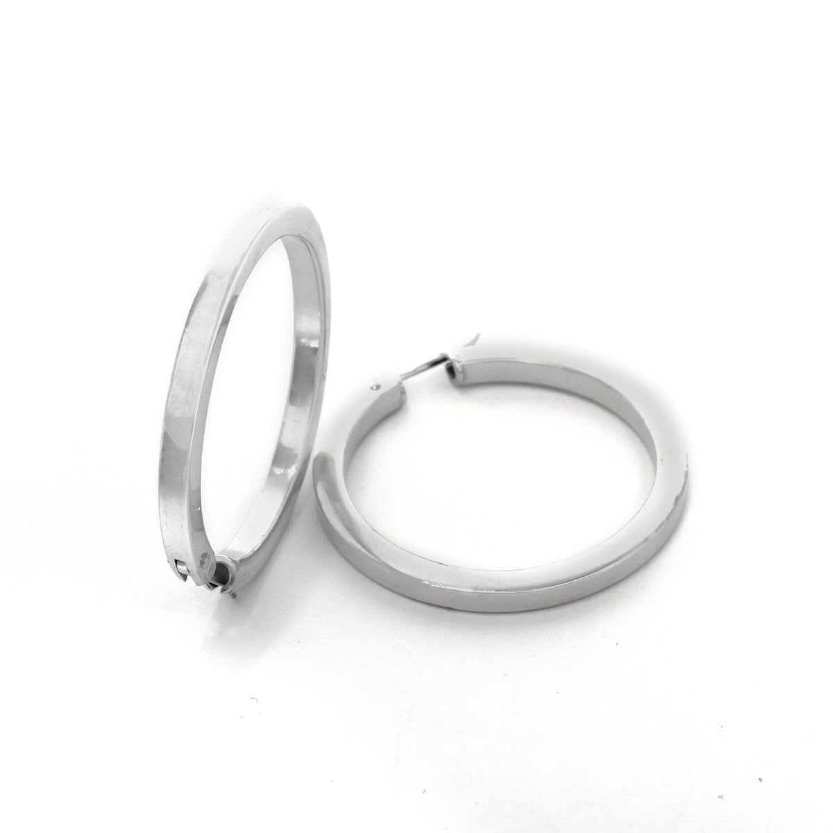 Pair of silver hoop earrings on a white background