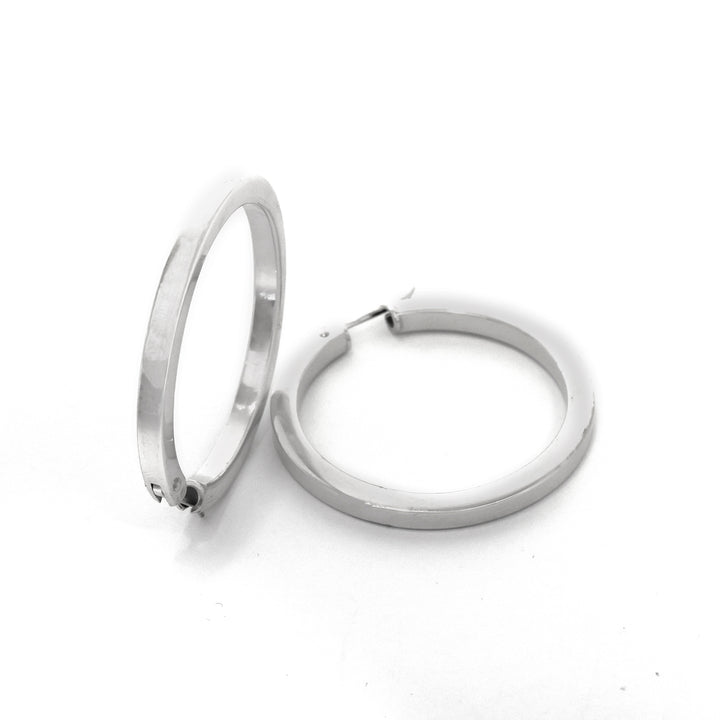 Pair of silver hoop earrings on a white background