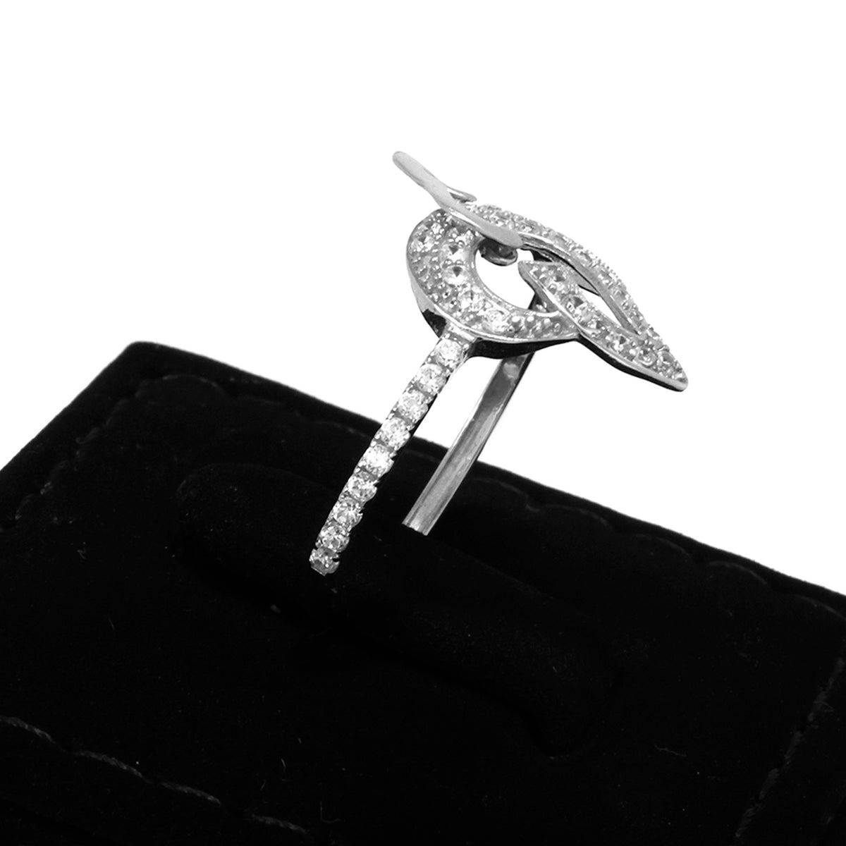Silver brooch with gemstones on a black cushion