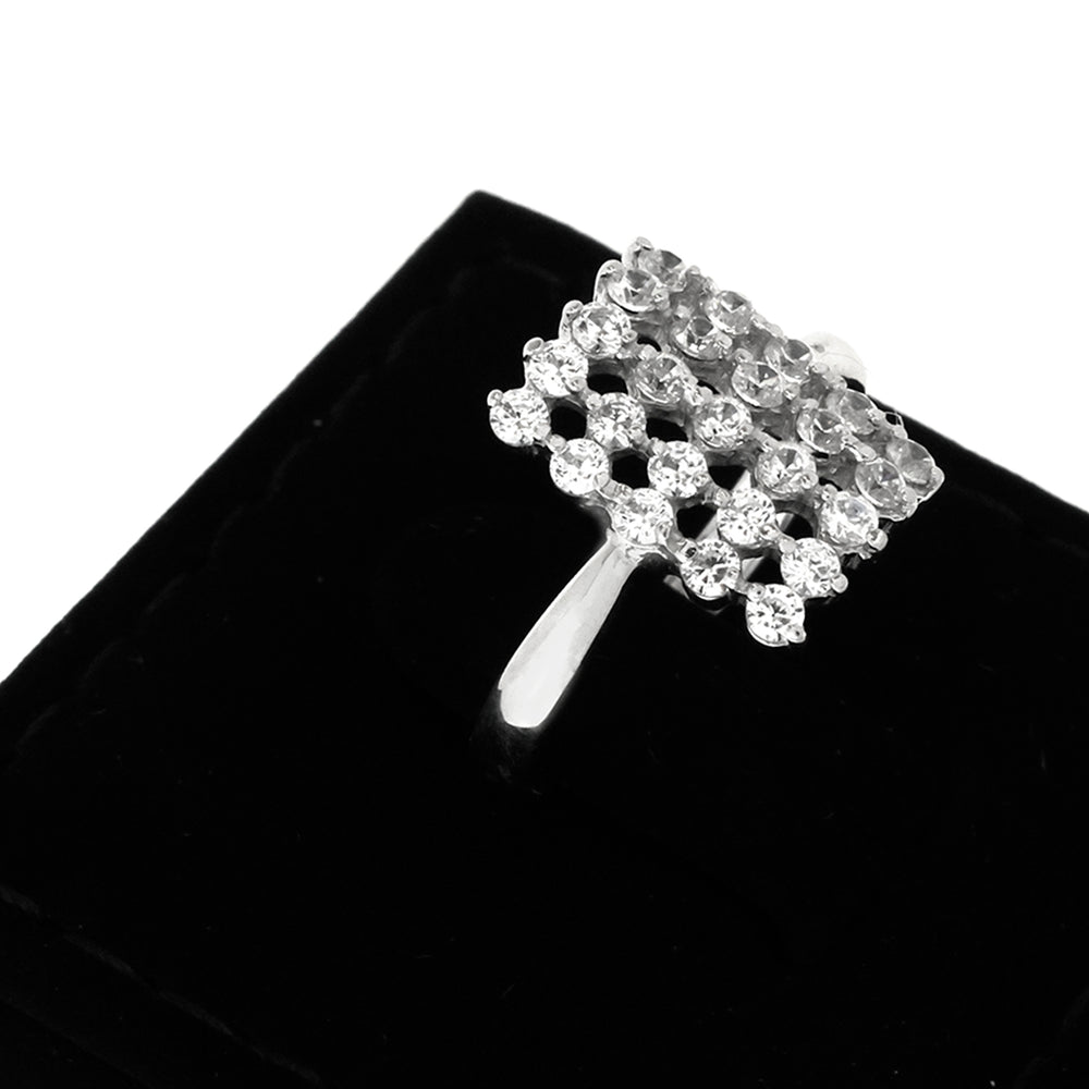 Silver brooch with crystal design on a black background