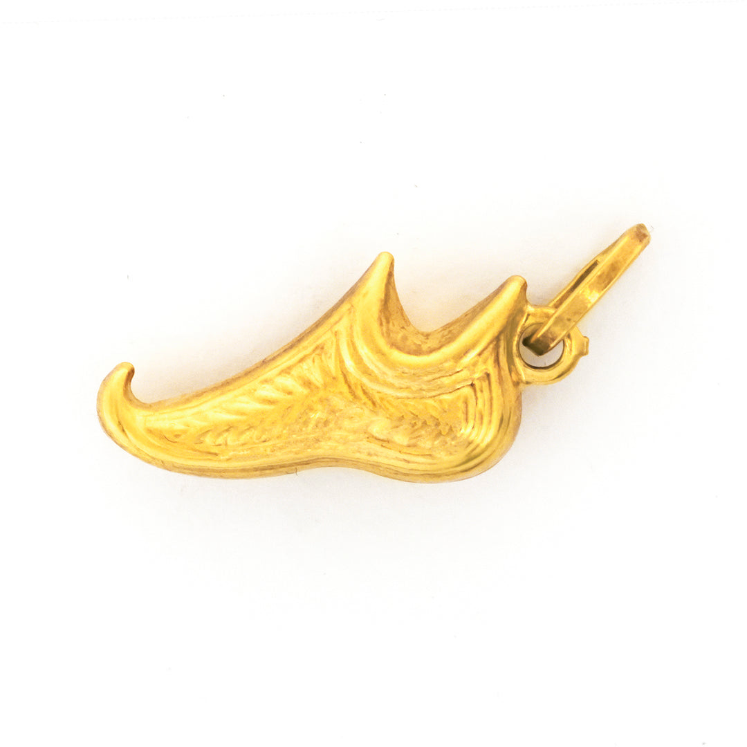 Gold shoe-shaped pendant on a white background