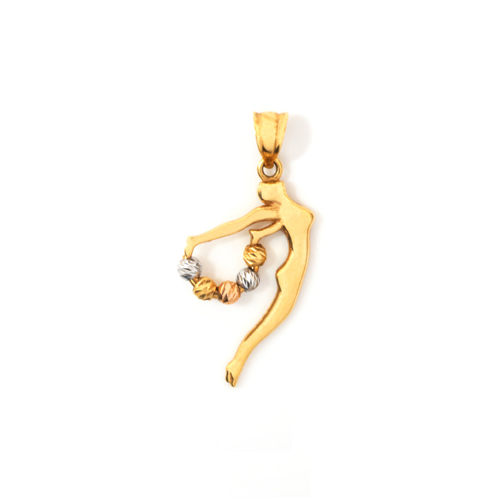 A gold pendant shaped like a stylized dancer or figure holding a small cluster of twisted beads in one hand, shown on a plain white background.