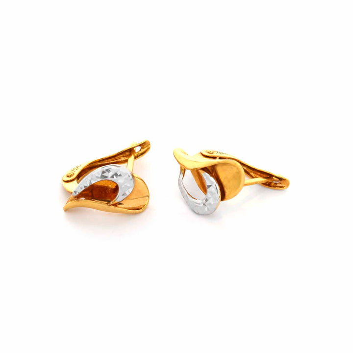 Gold and silver cufflinks on a white background