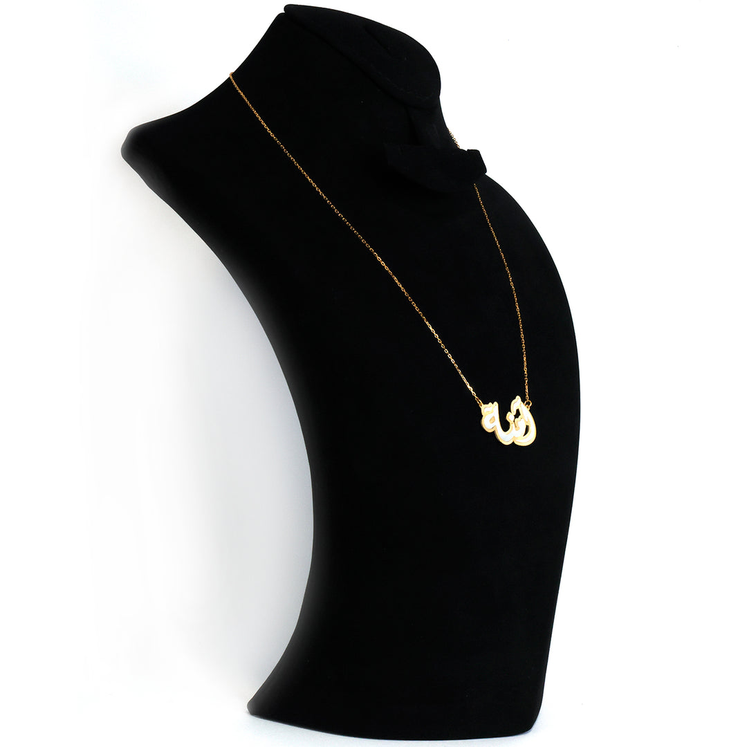 Gold necklace with a pendant on a black mannequin bust against a white background