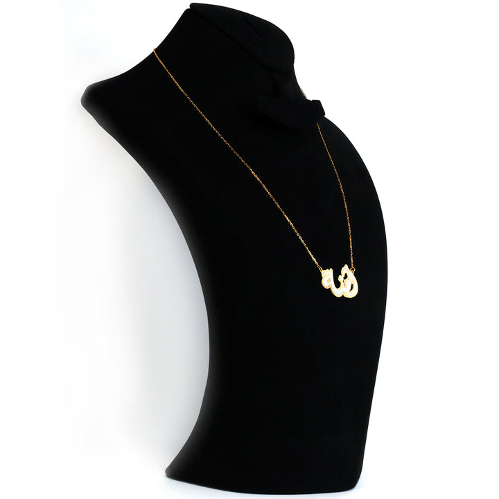 Gold necklace with a pendant on a black mannequin bust against a white background