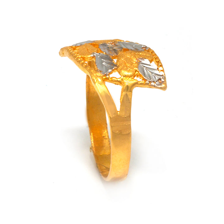 Gold ring with silver leaf designs on a white background