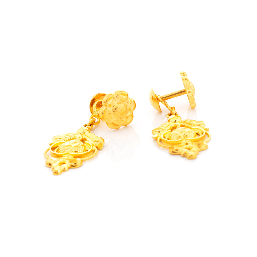 Pair of gold earrings on a white background
