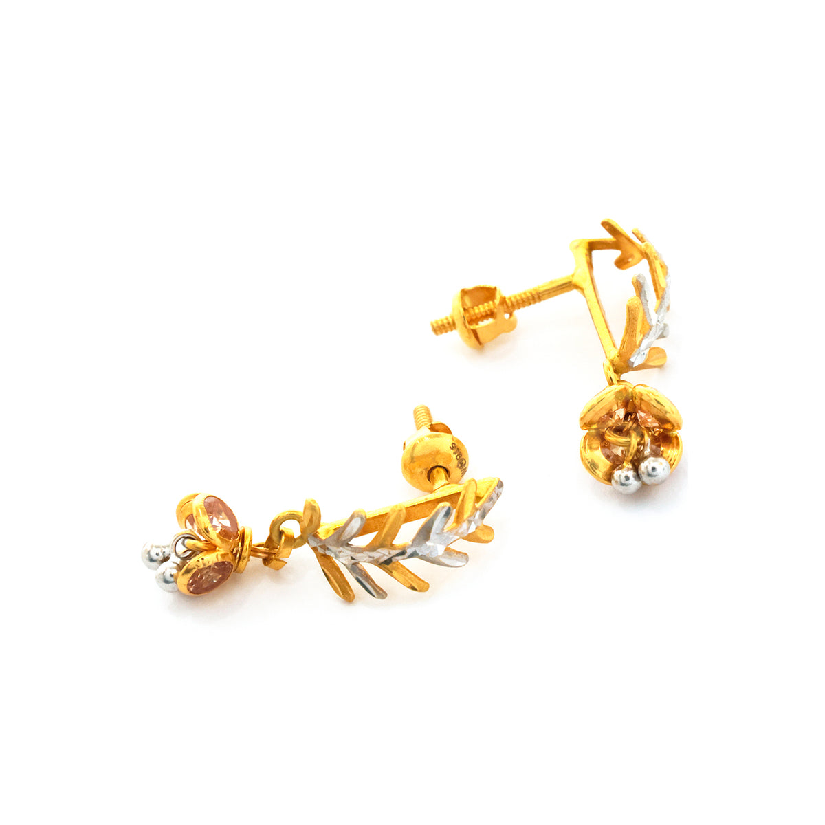 Gold and silver earrings on a white background