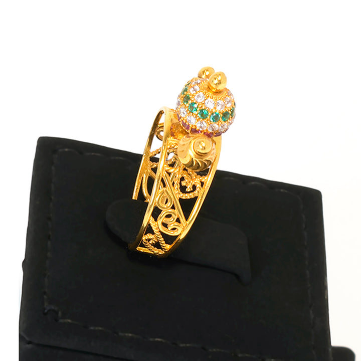 Gold bracelet with decorative clasp on a black stand