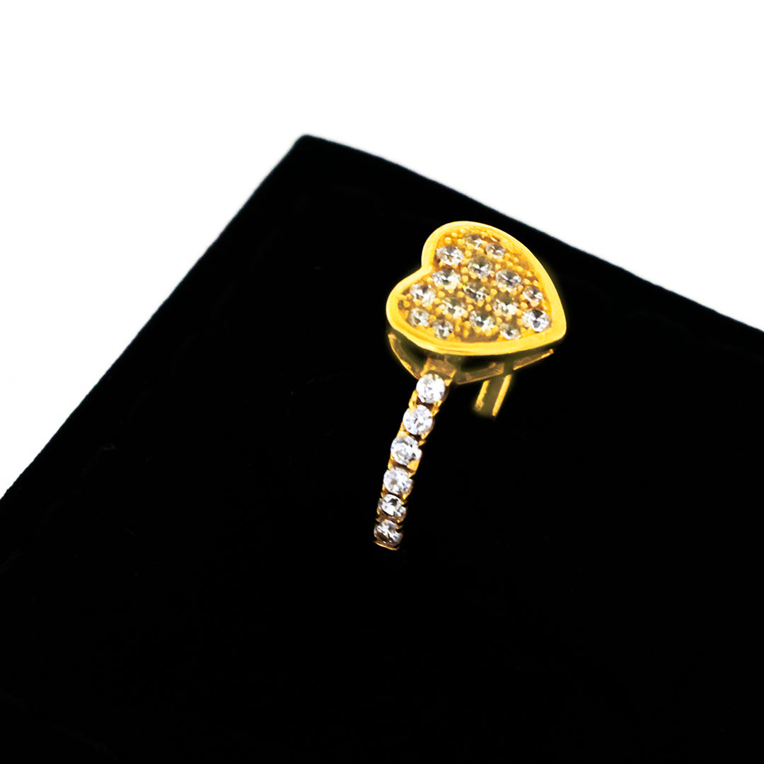 Gold heart-shaped ring with embedded stones on a black background