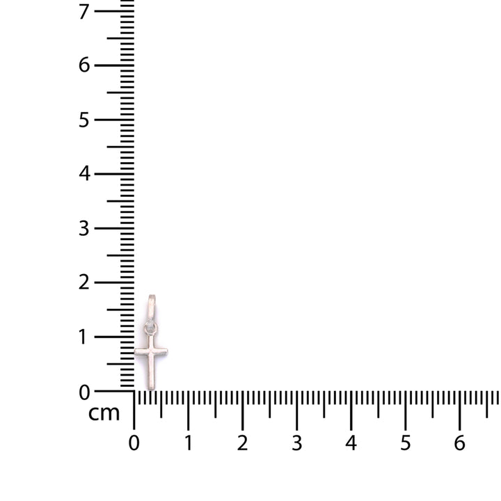 A small silver cross pendant with a halo detail, shown next to a centimeter ruler for scale on a plain white background.