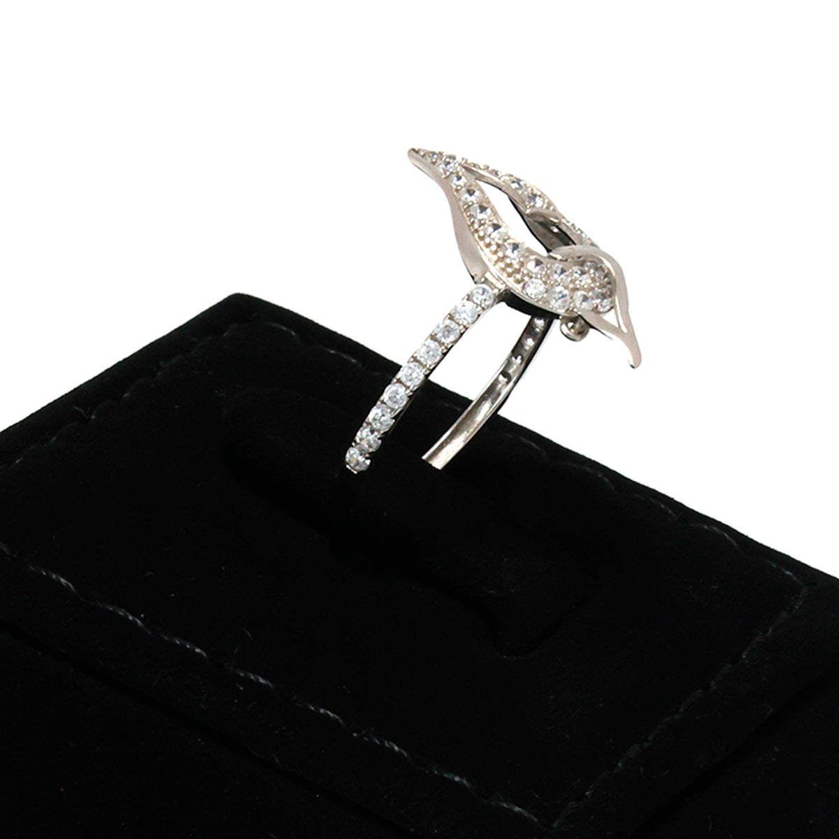 Silver leaf-shaped ring with gemstones on a black cushion