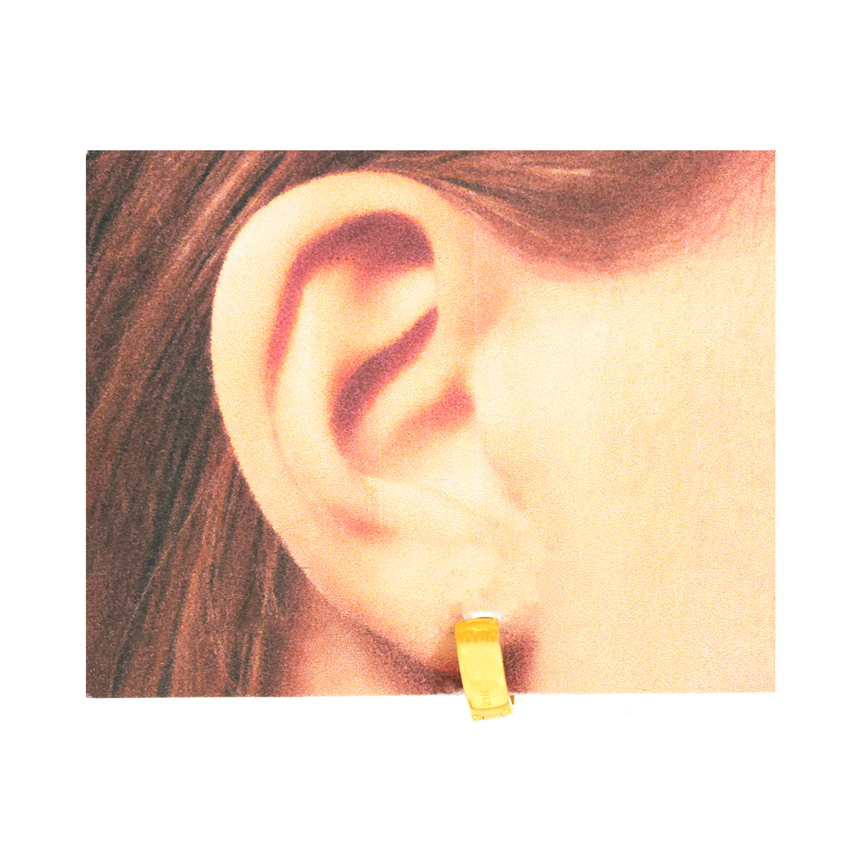 Close-up of an ear wearing a yellow earring with a plain background