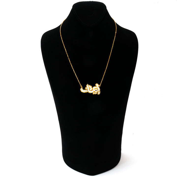 Silver necklace on a black mannequin bust against a white background
