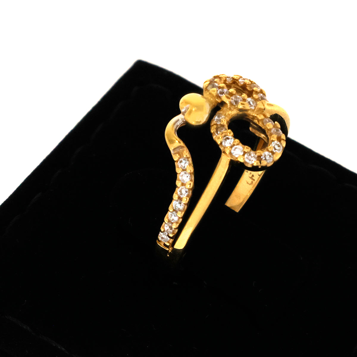 Gold earring with clear stones on a black background
