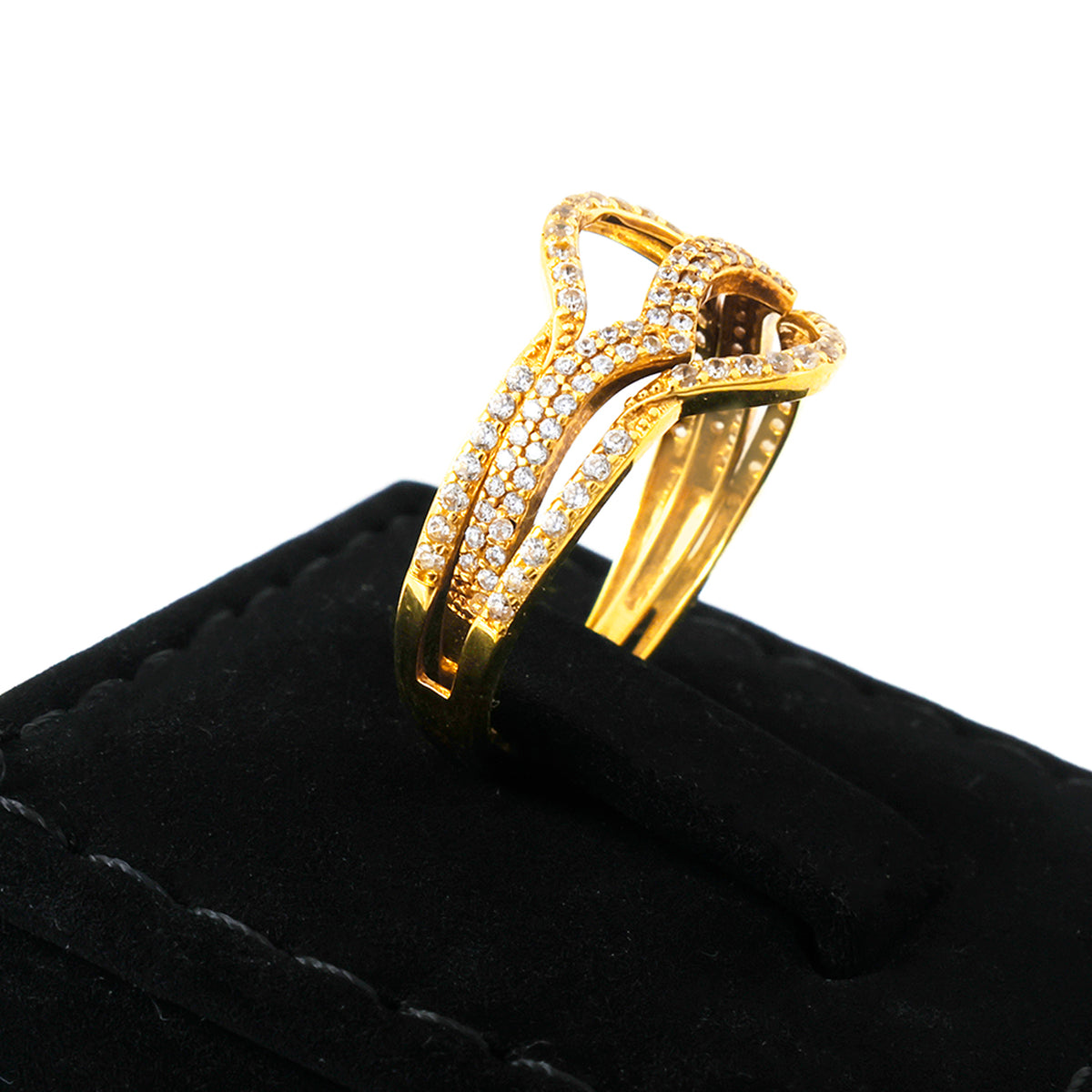 Gold ring with diamond accents on a black cushion
