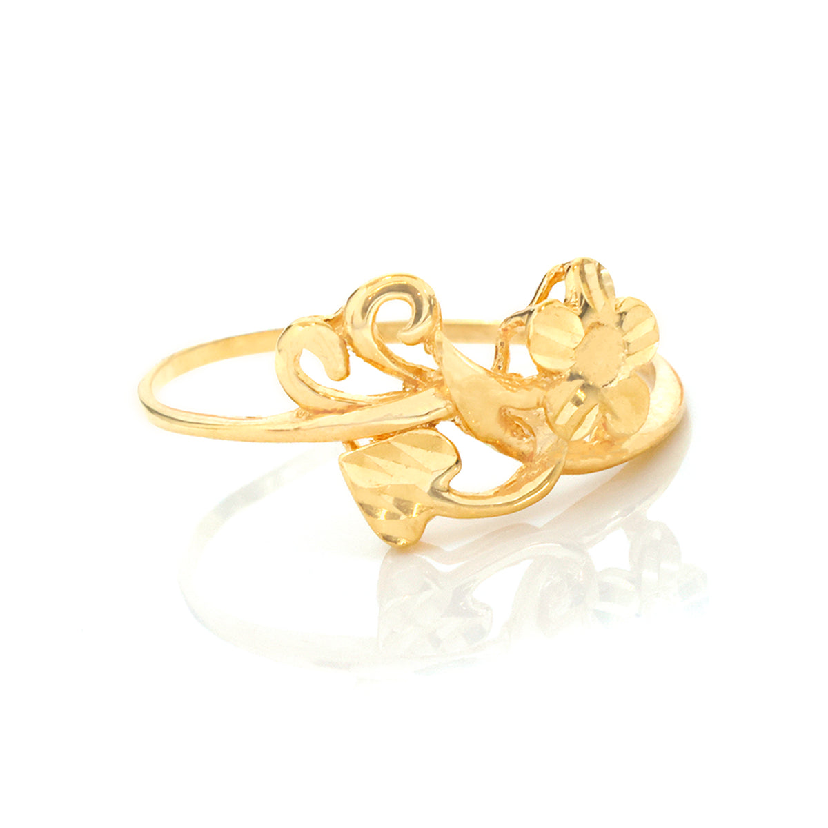 A yellow gold ring featuring a sculpted floral and vine motif, displayed on a clean white background with a soft reflection below.