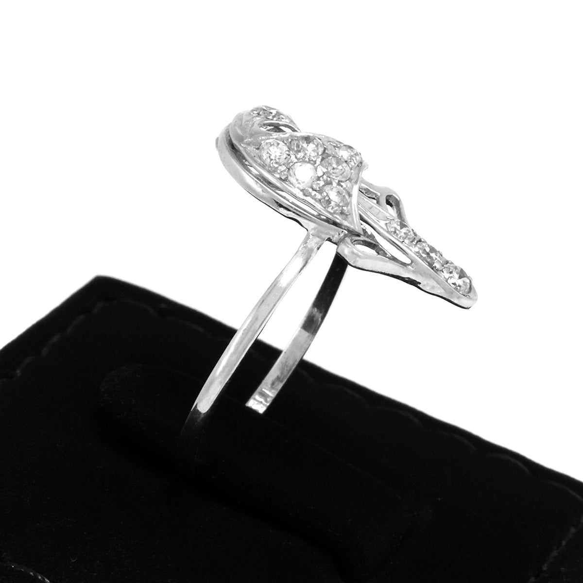 Silver ring with gemstones on a black cushion