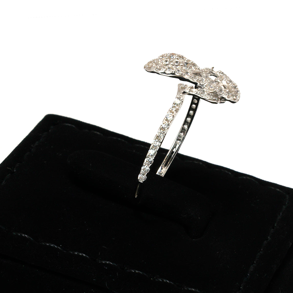 Silver hair clip with decorative design on a black velvet background