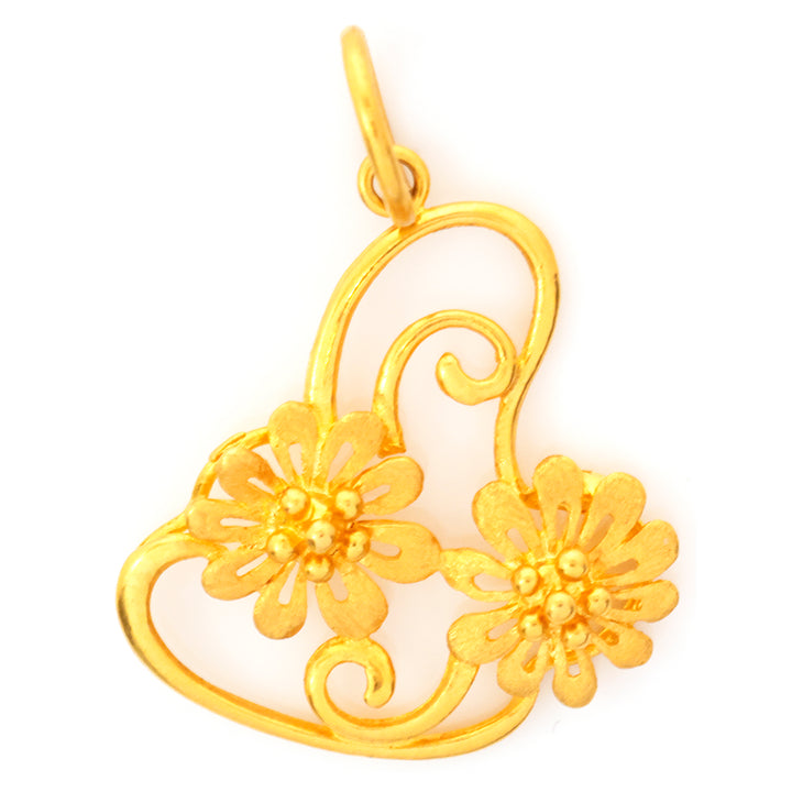 Gold pendant with floral designs on a white background