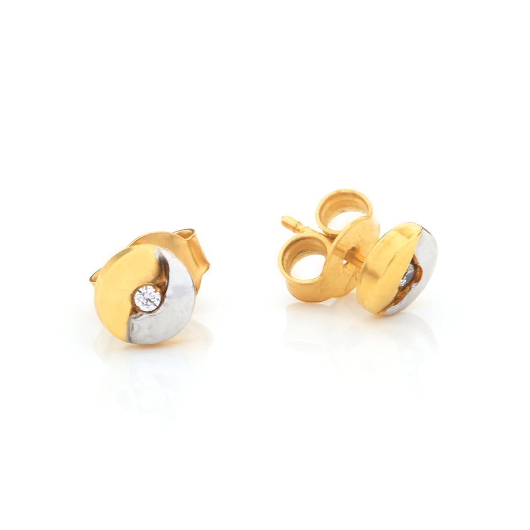 A pair of gold and silver two-tone stud earrings with a small clear gemstone, shown on a clean white background.
