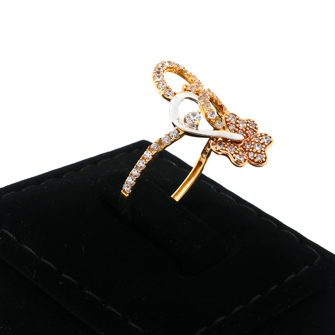 Gold butterfly-shaped brooch with crystals on a black cushion