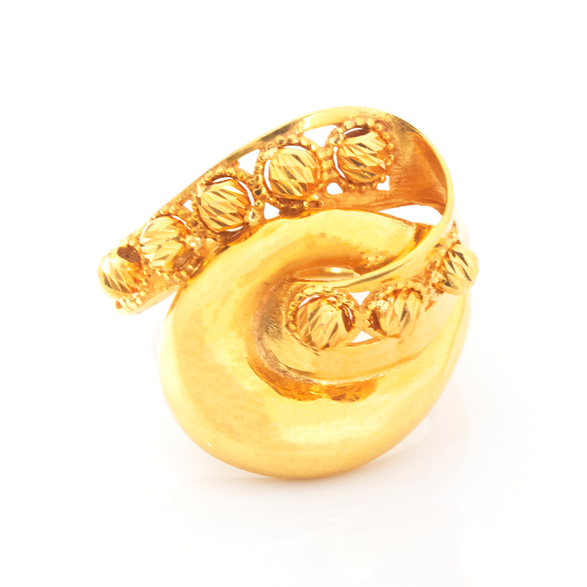 A gold ring with a sculptural, organic spiral shape and textured beaded details along the top band, shown on a plain white background.