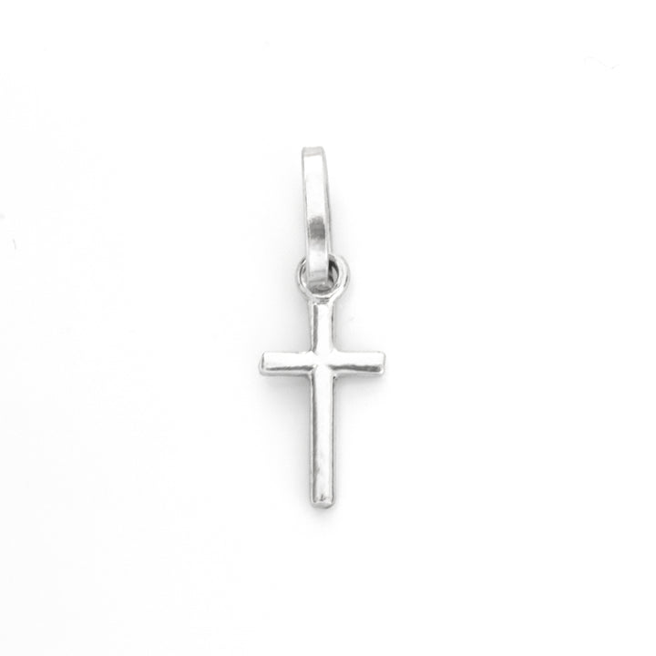 A small sterling silver cross pendant with a polished finish and a top loop, centered on a plain white background.