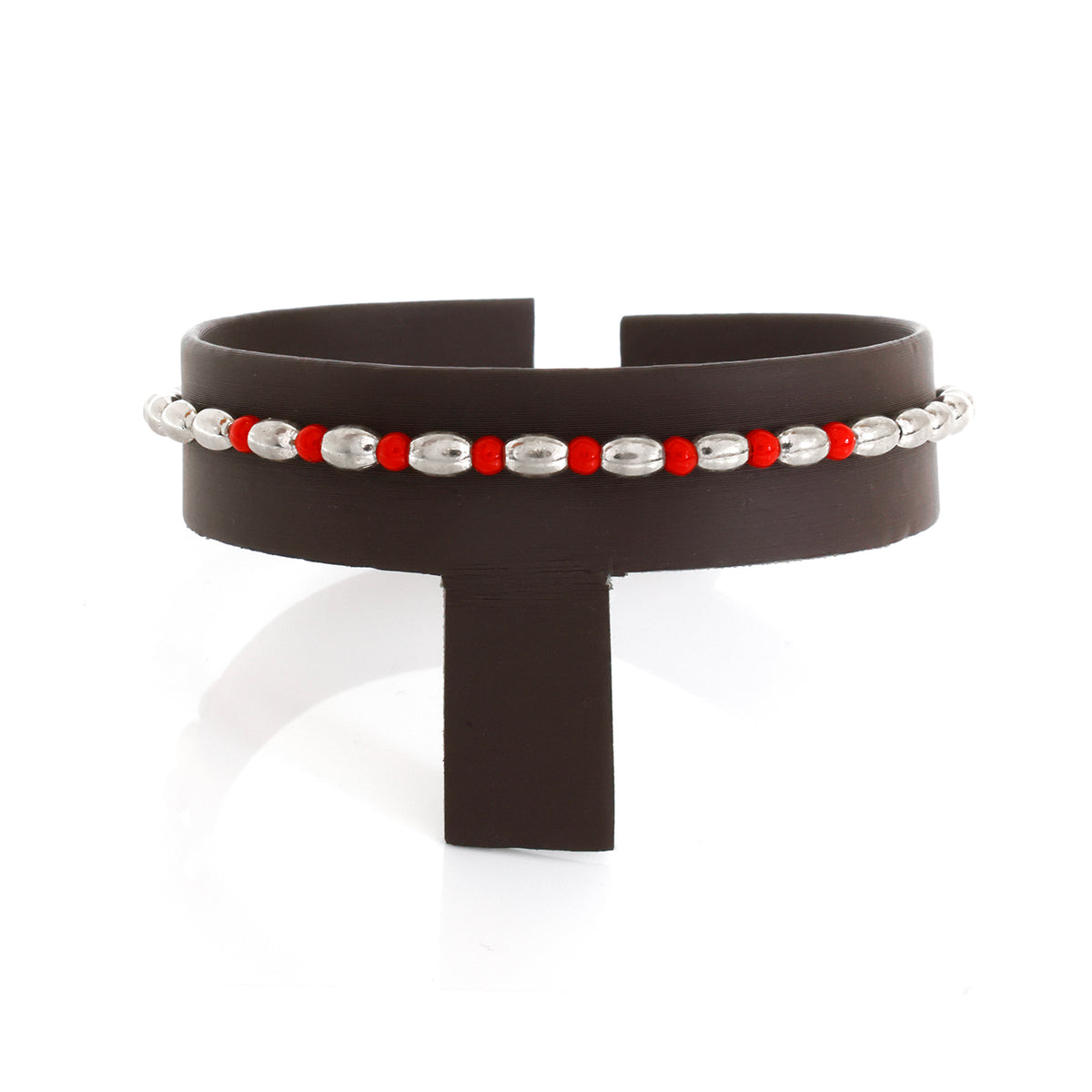 Black cuff bracelet with red and silver beads on a white background