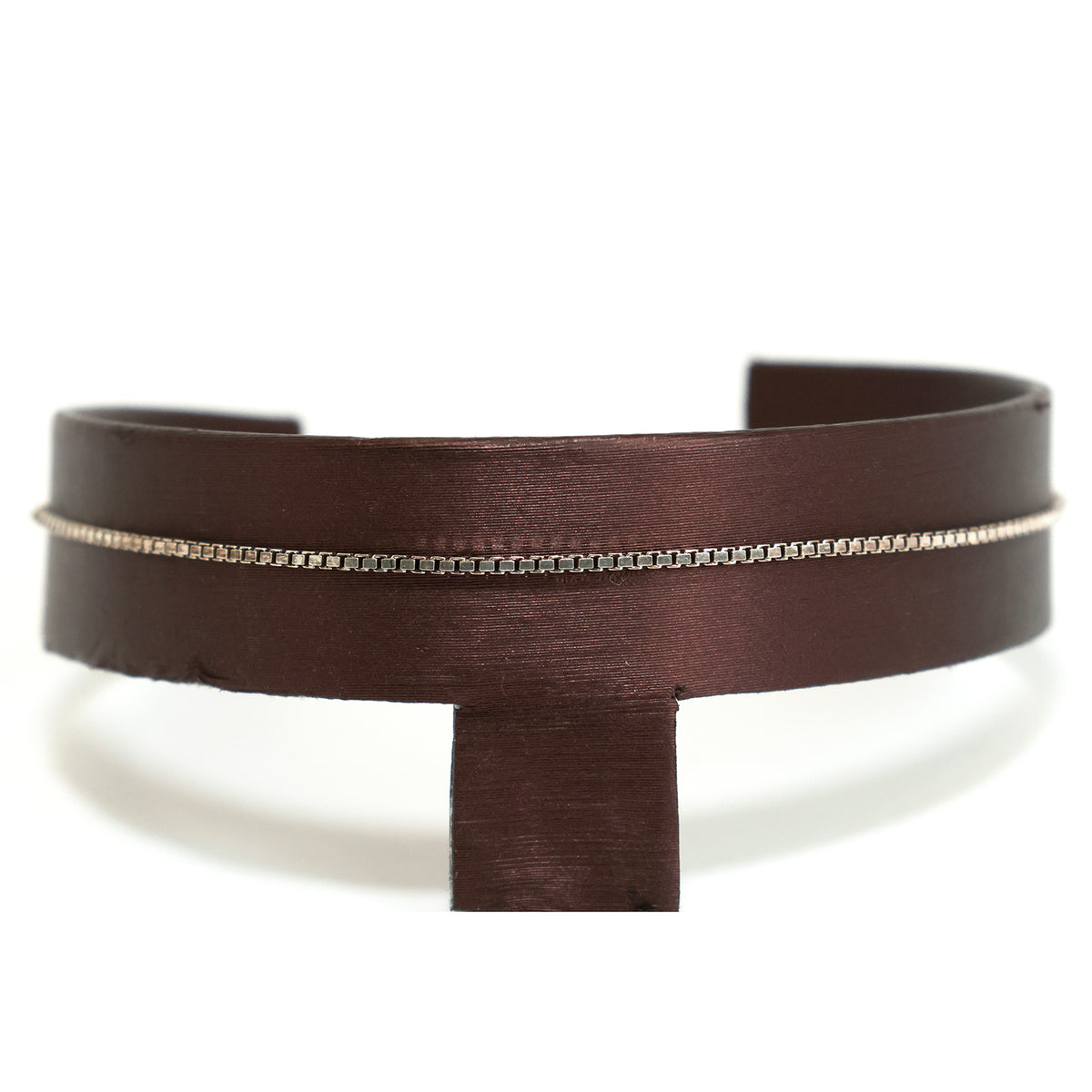 Brown leather belt with a silver chain on a white background