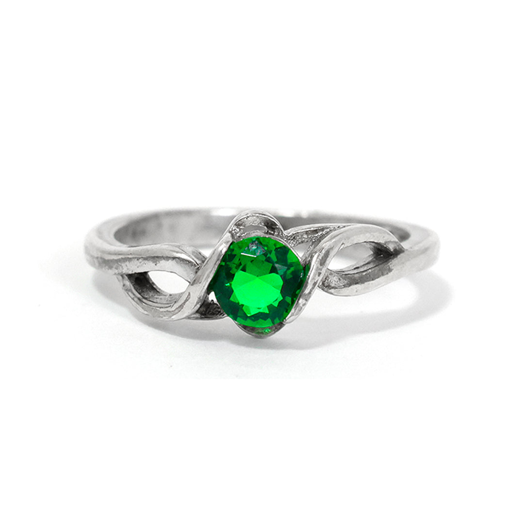 Silver ring with a green gemstone on a white background