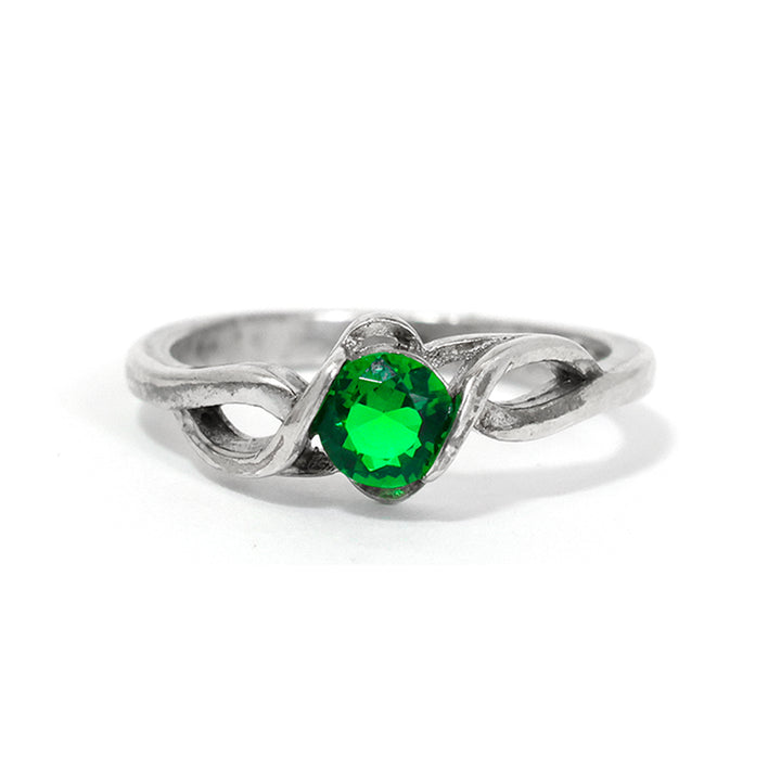 Silver ring with a green gemstone on a white background
