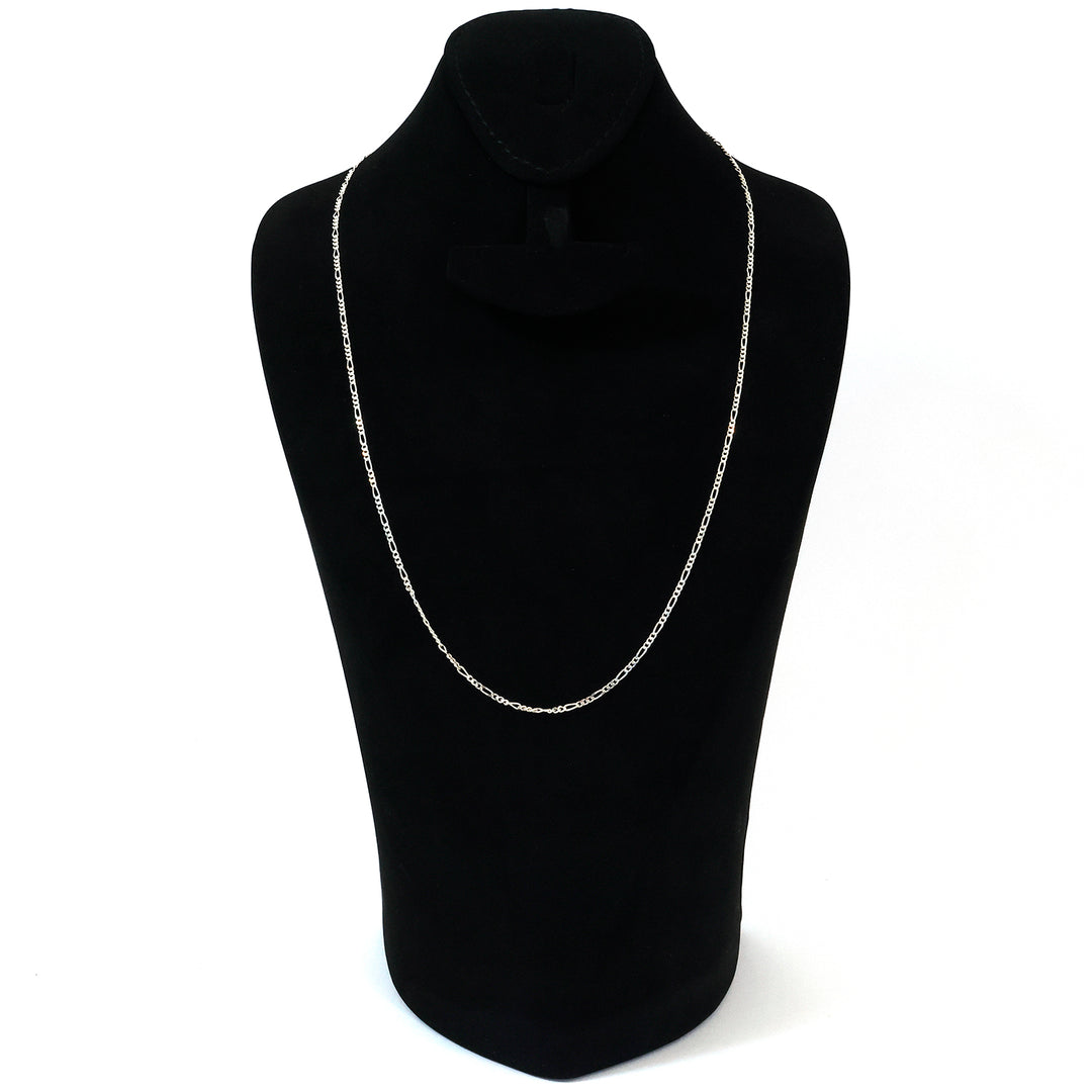 Silver necklace on a black mannequin bust against a white background