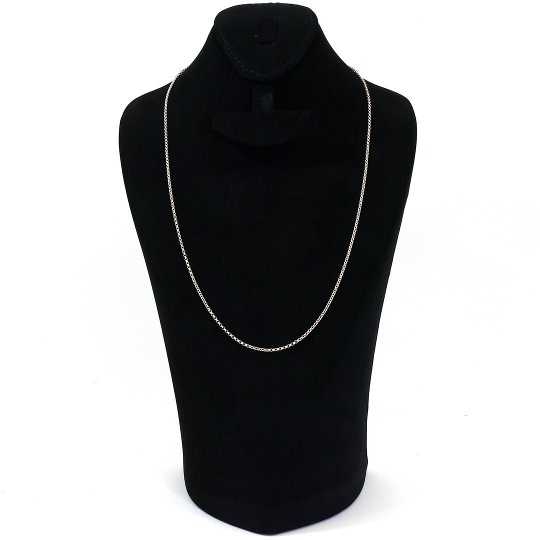 Silver necklace on a black mannequin bust against a white background