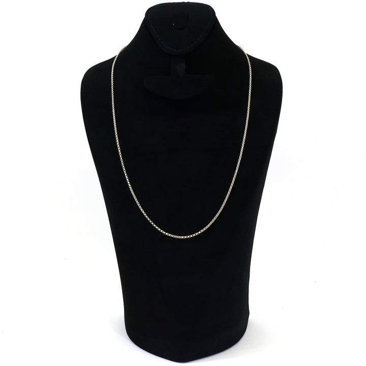 Silver necklace on a black mannequin bust against a white background