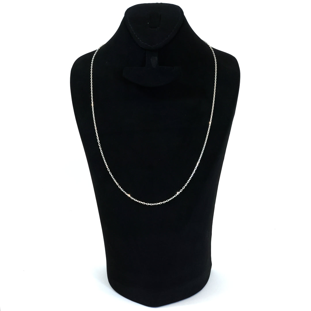 Black turtleneck sweater with a silver chain necklace on a mannequin against a white background