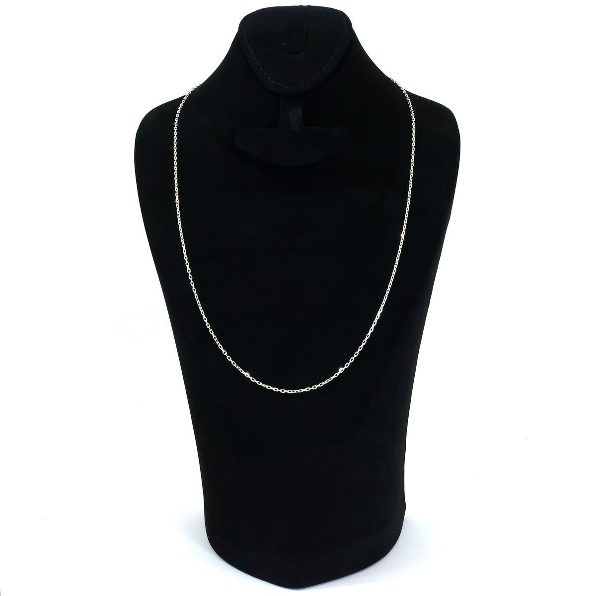 Black turtleneck sweater with a silver chain necklace on a mannequin against a white background