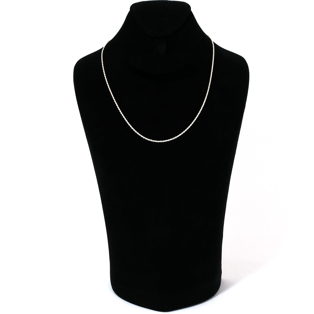 Black turtleneck sweater on a mannequin with a silver necklace against a white background
