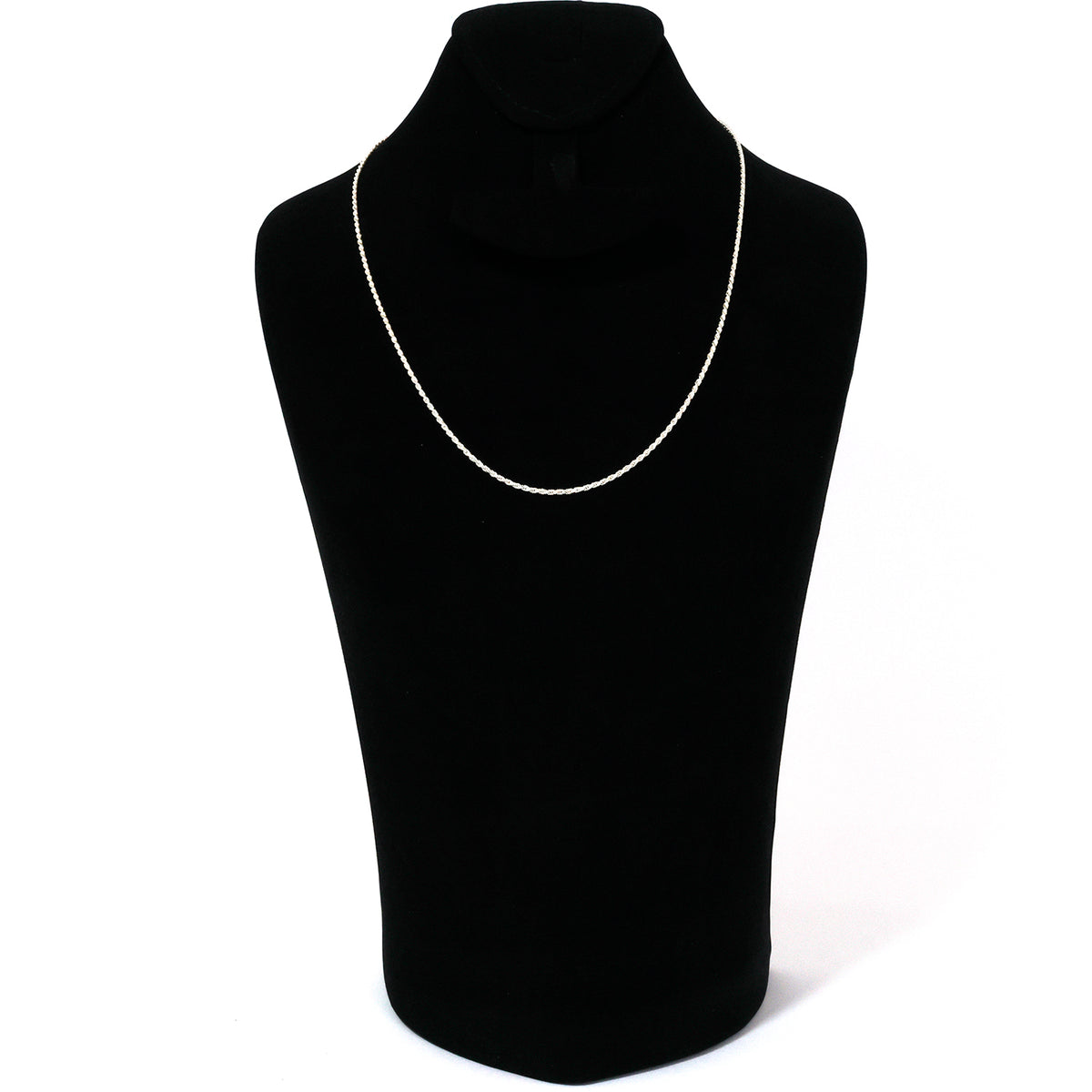 Black turtleneck sweater on a mannequin with a silver necklace against a white background