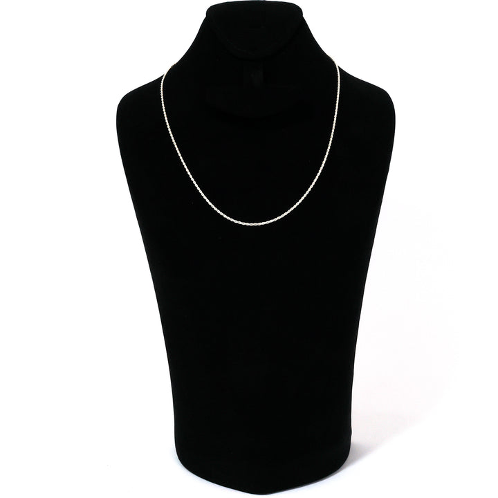 Black turtleneck sweater on a mannequin with a silver necklace against a white background