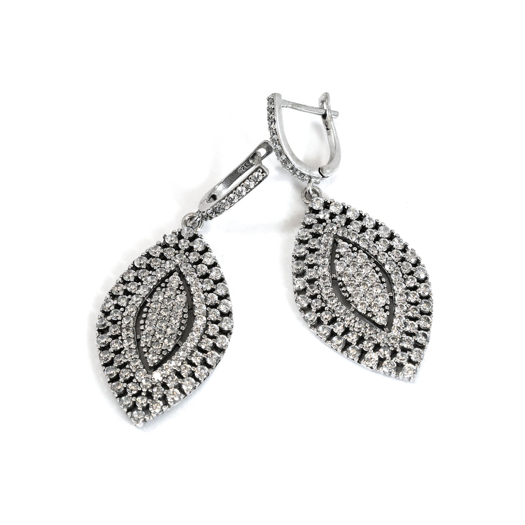 Pair of silver earrings with leaf design on a white background