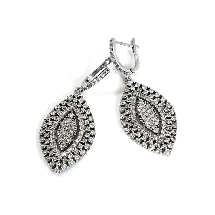 Pair of silver earrings with leaf design on a white background
