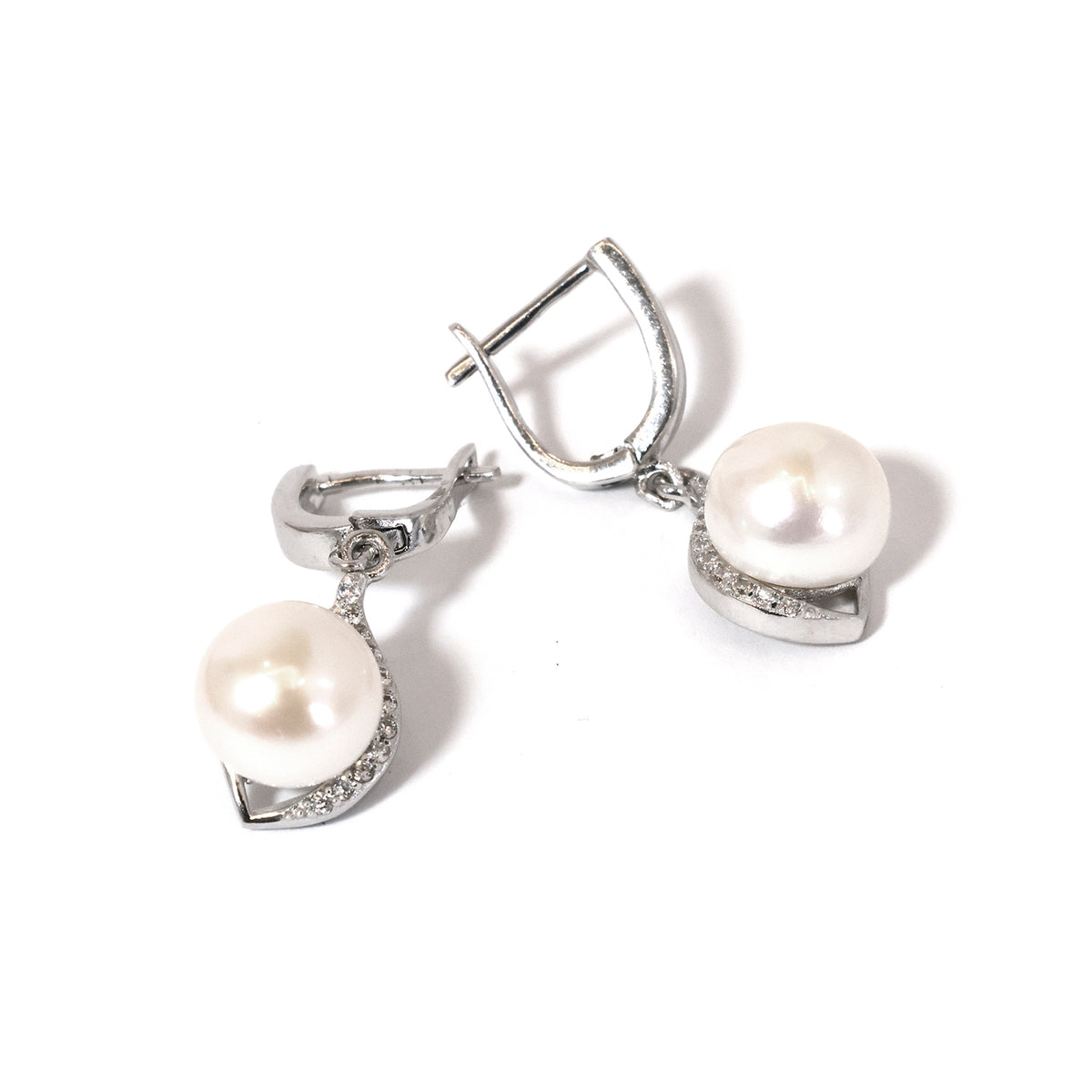 Pair of silver earrings with pearl drops on a white background