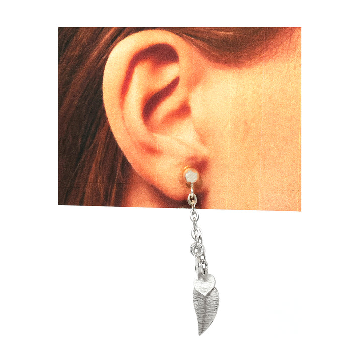 Silver bracelet with heart-shaped charms on a white background