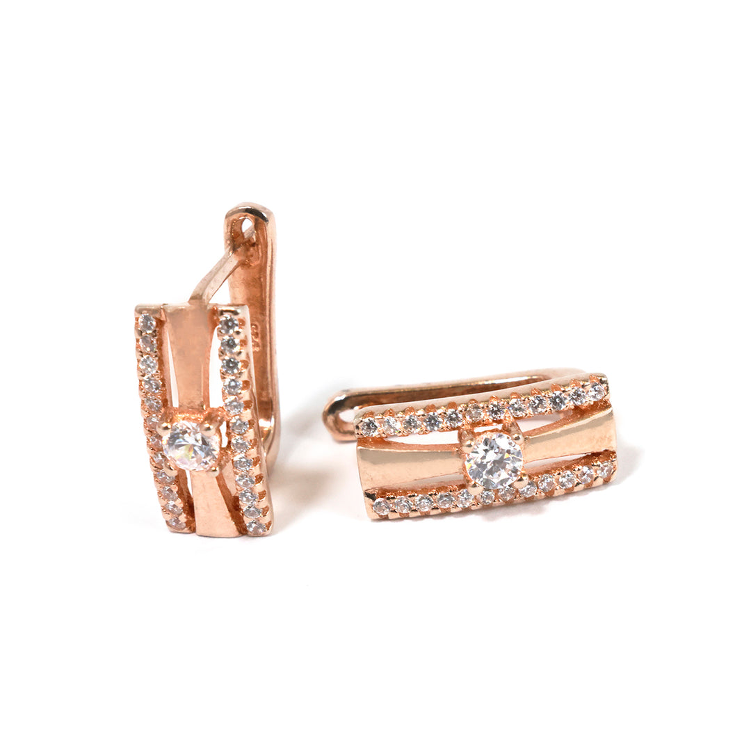 Rose gold earrings with clear gemstones on a white background