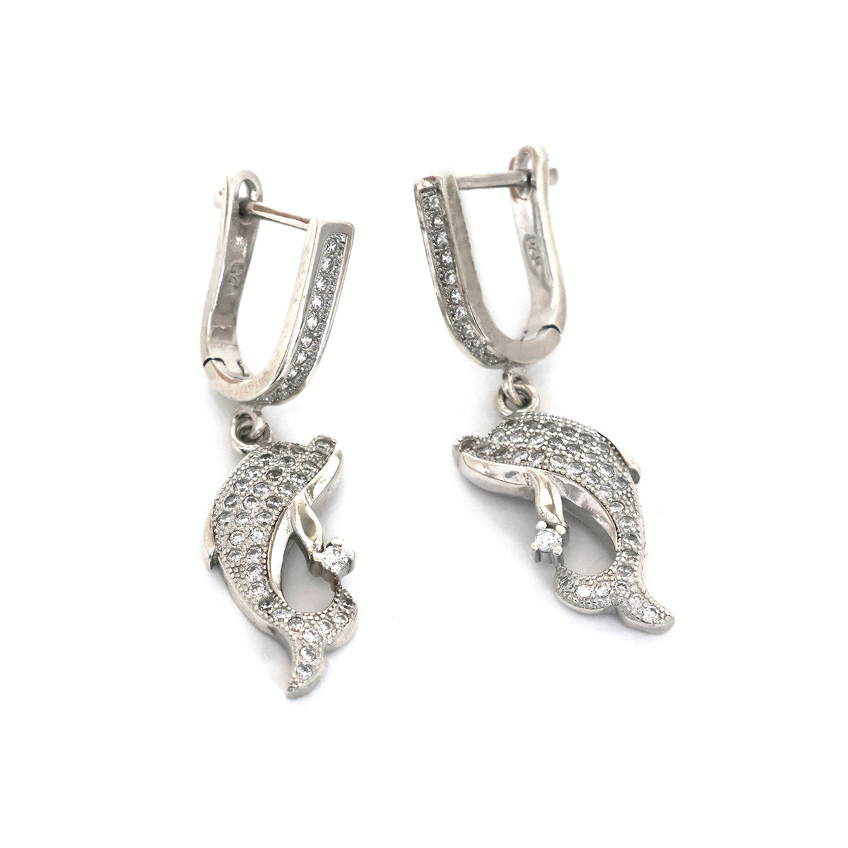 Pair of silver dolphin-shaped earrings on a white background