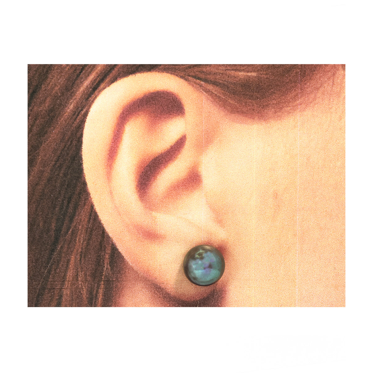 Close-up of an ear wearing a dark green earring with a white background